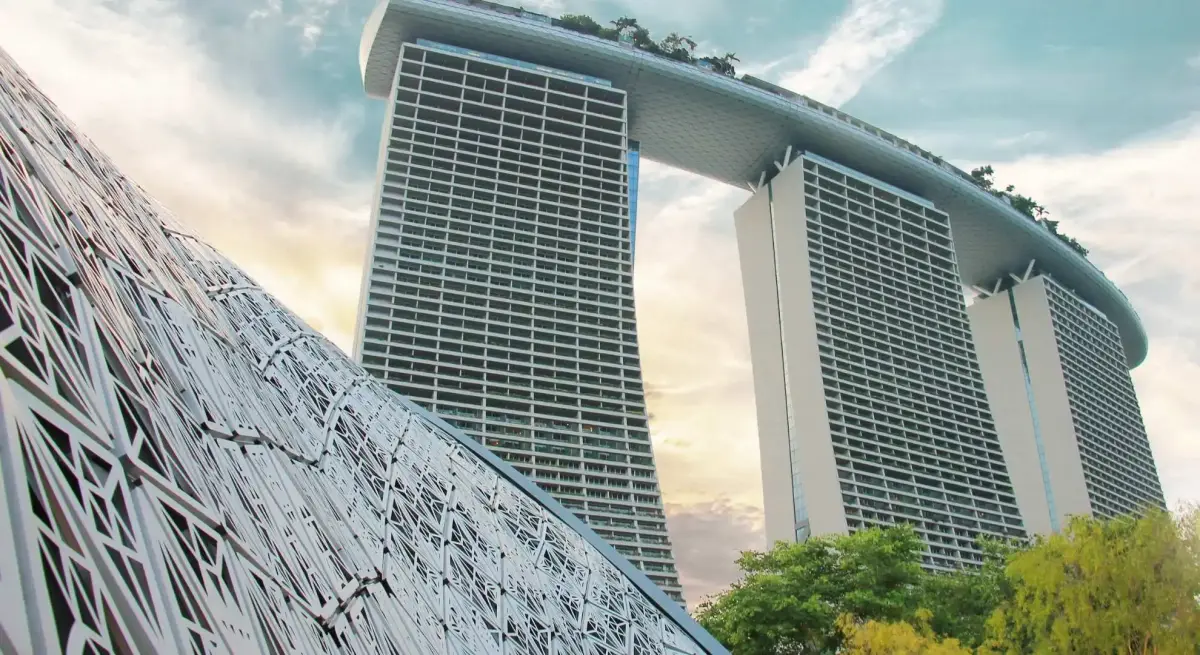 Marina Bay Sands iconic three-tower hotel rising above Singapore's waterfront, destination for private jet charter arrivals