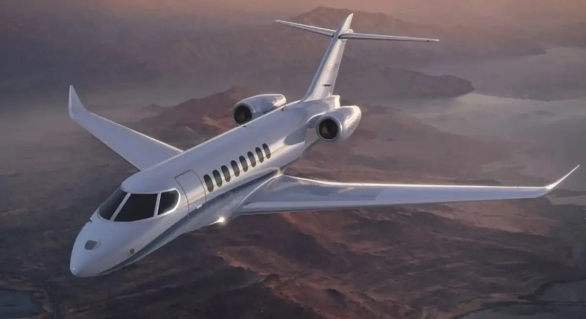 SyberJet SJ36 private jet cruising over dramatic mountain terrain at dusk, showcasing its sleek twin-engine design for sustainable aviation charter