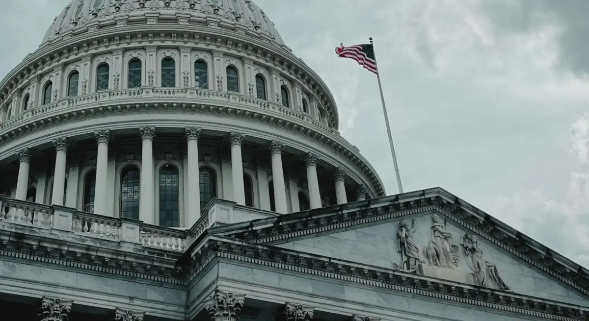 US Capitol building dome with American flag flying overhead, representing federal government decisions affecting FAA operations and private aviation regulations